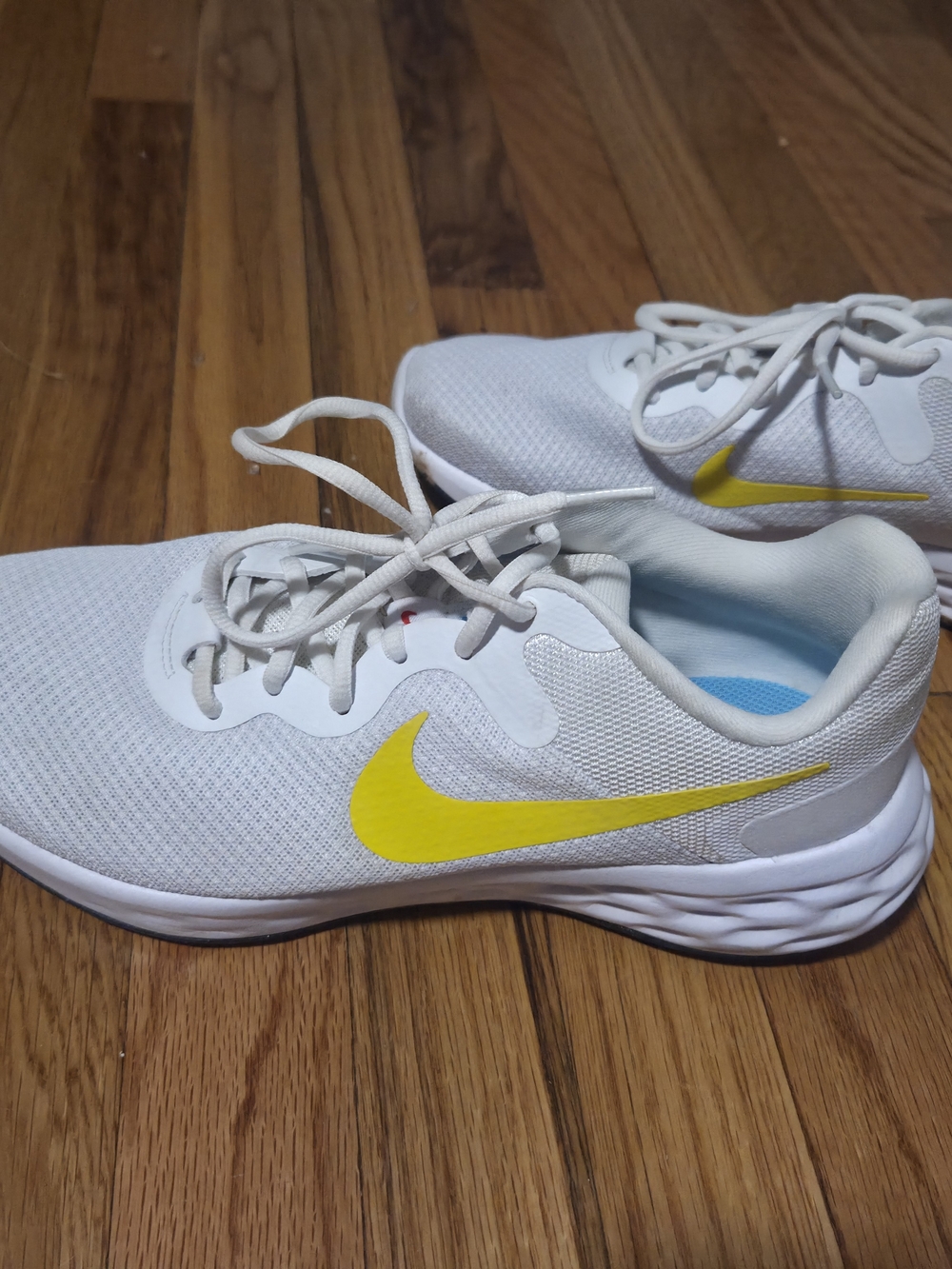 Nike Women's White Athletic Shoes with Yellow Swoosh